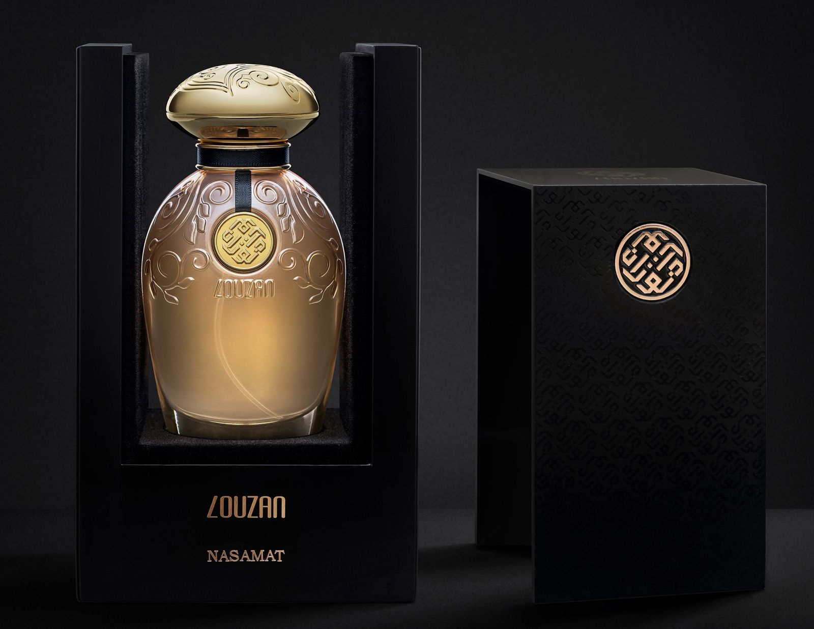 A perfume with its box placed on a black background