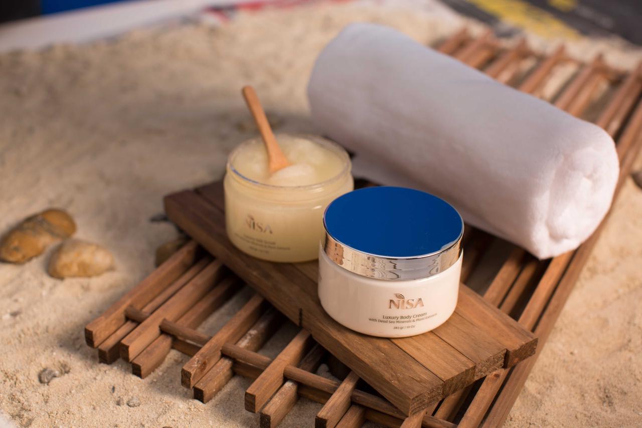 A body cream with a towel placed on a wooden stand.
